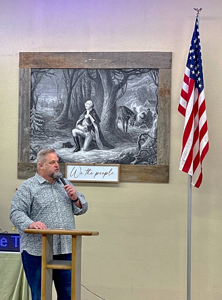 Lew speaking to the group at an event